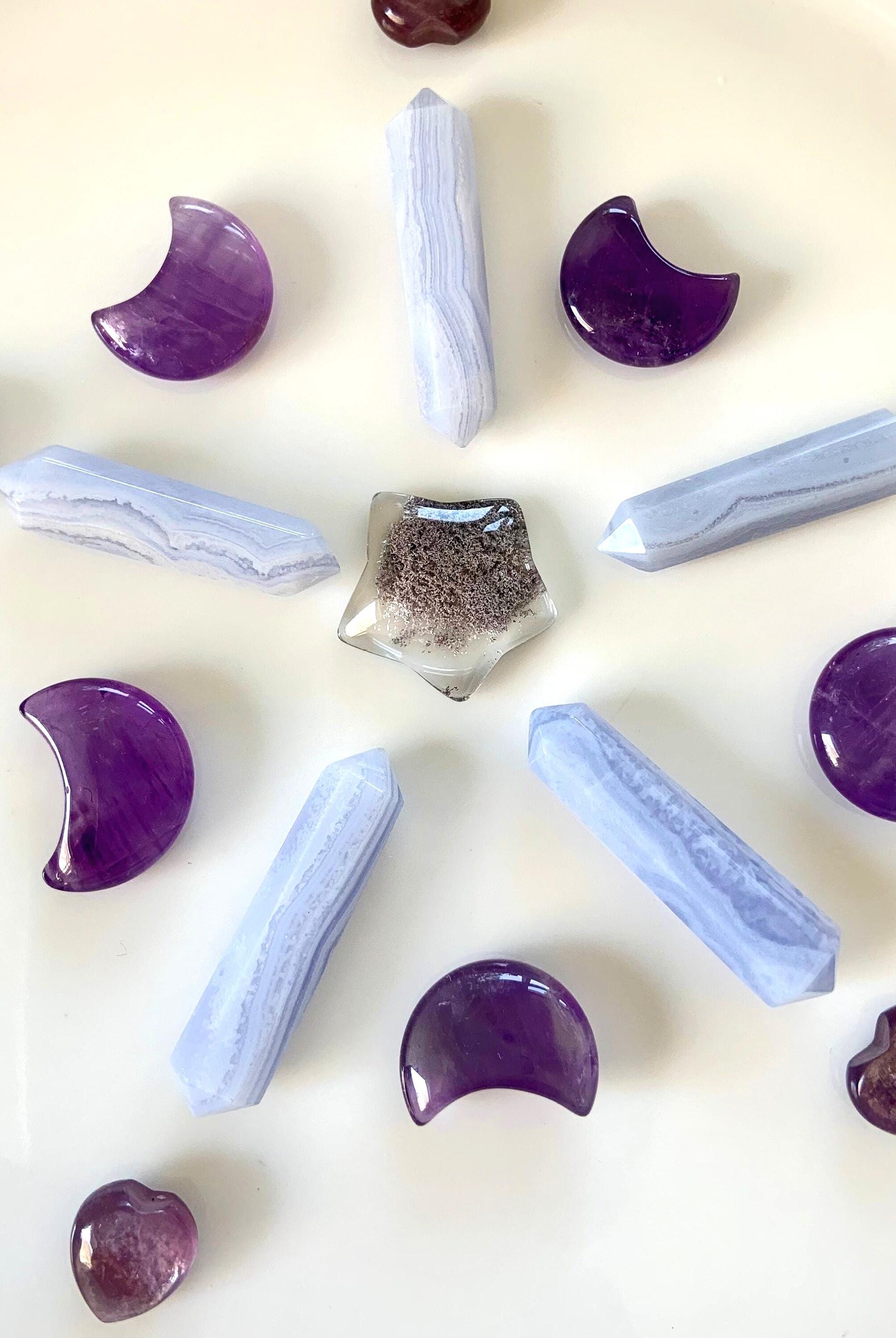 A crystal grid with amethyst moons, blue lace agate DT's, lepidolite hearts + a garden quartz star