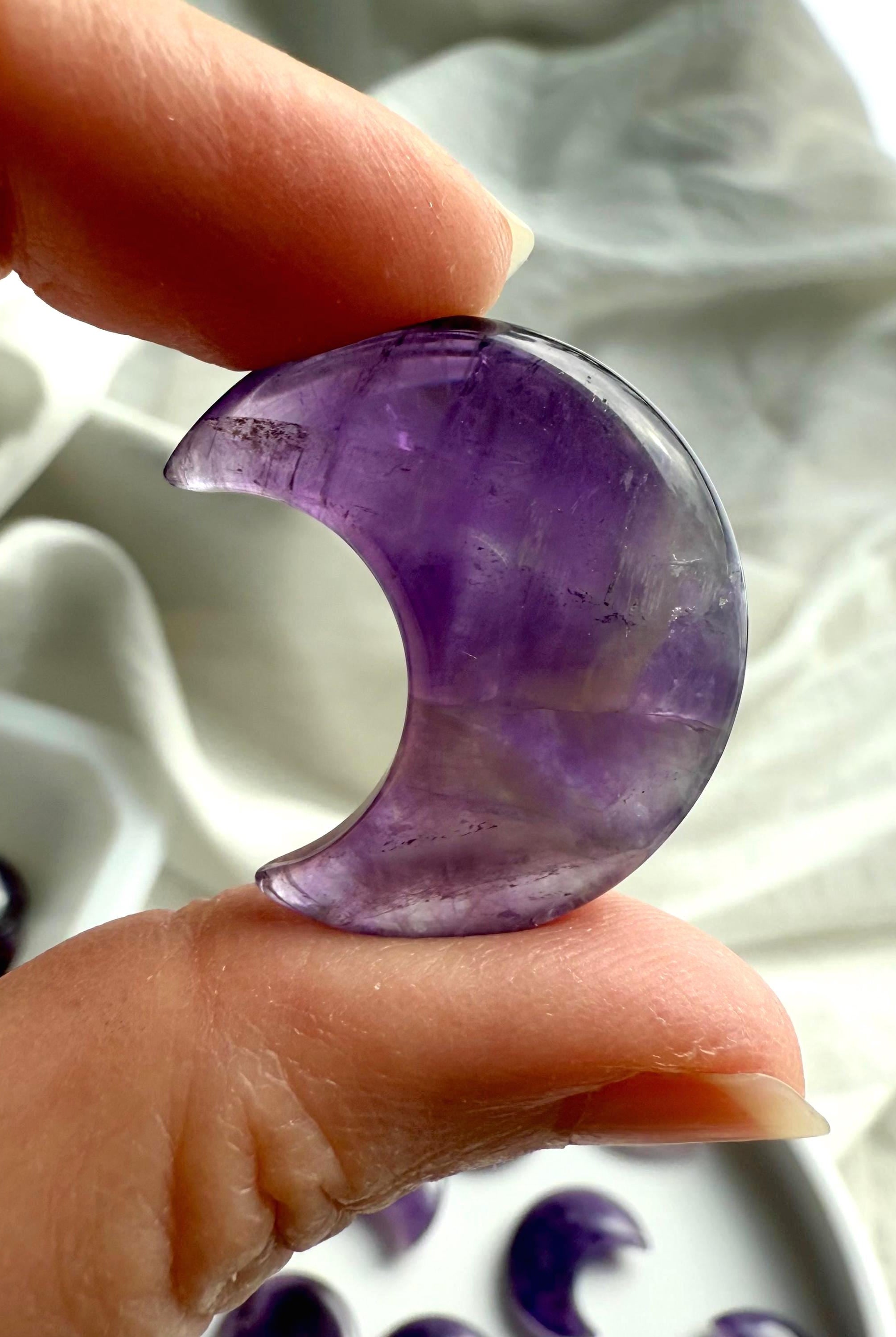 A closeup view of a dream amethyst moon with smokey quartz inclusions