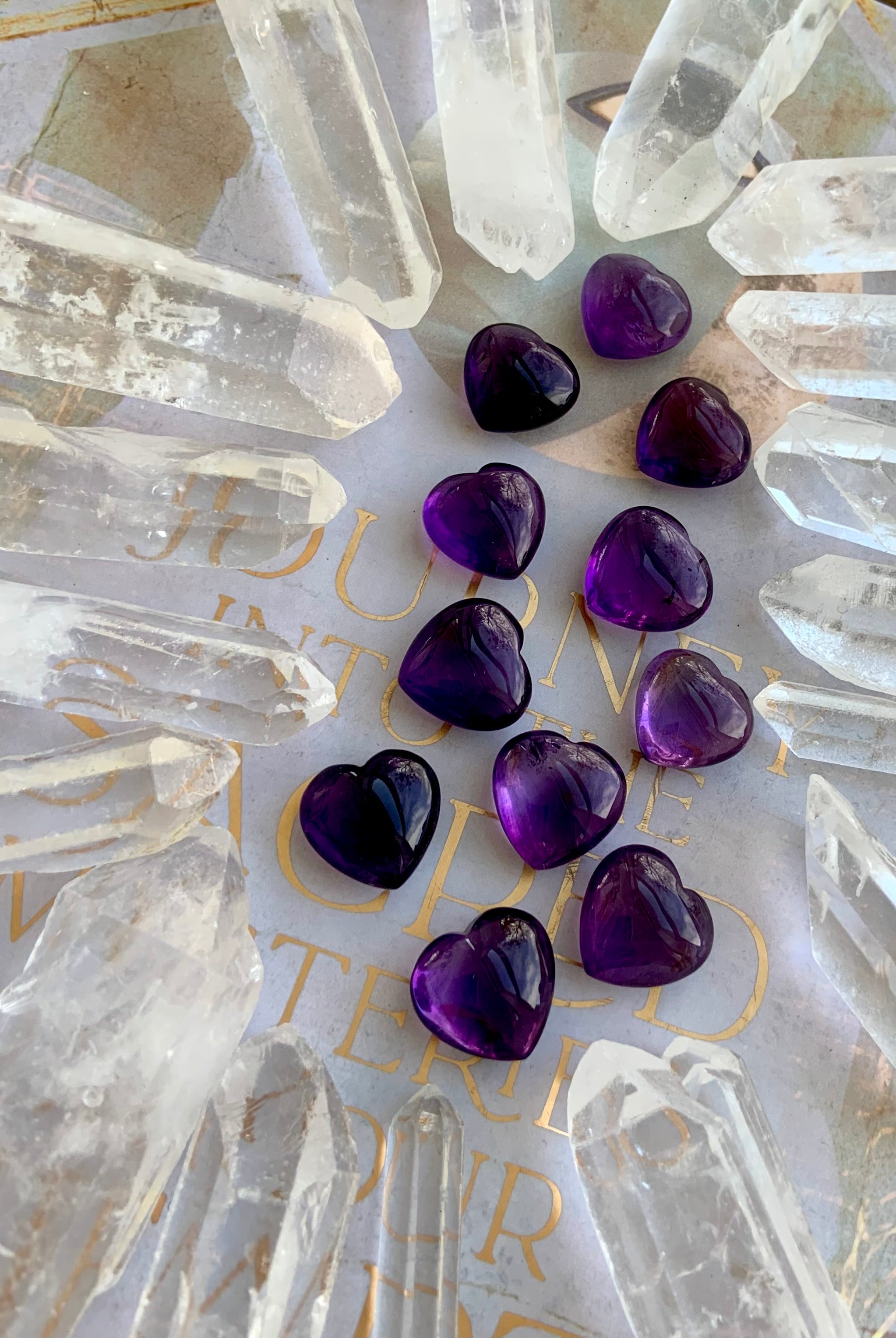 Wide angle view of Mini Amethyst hearts in a quartz point grid — powerful crystal arrangement for amplification and energy focus