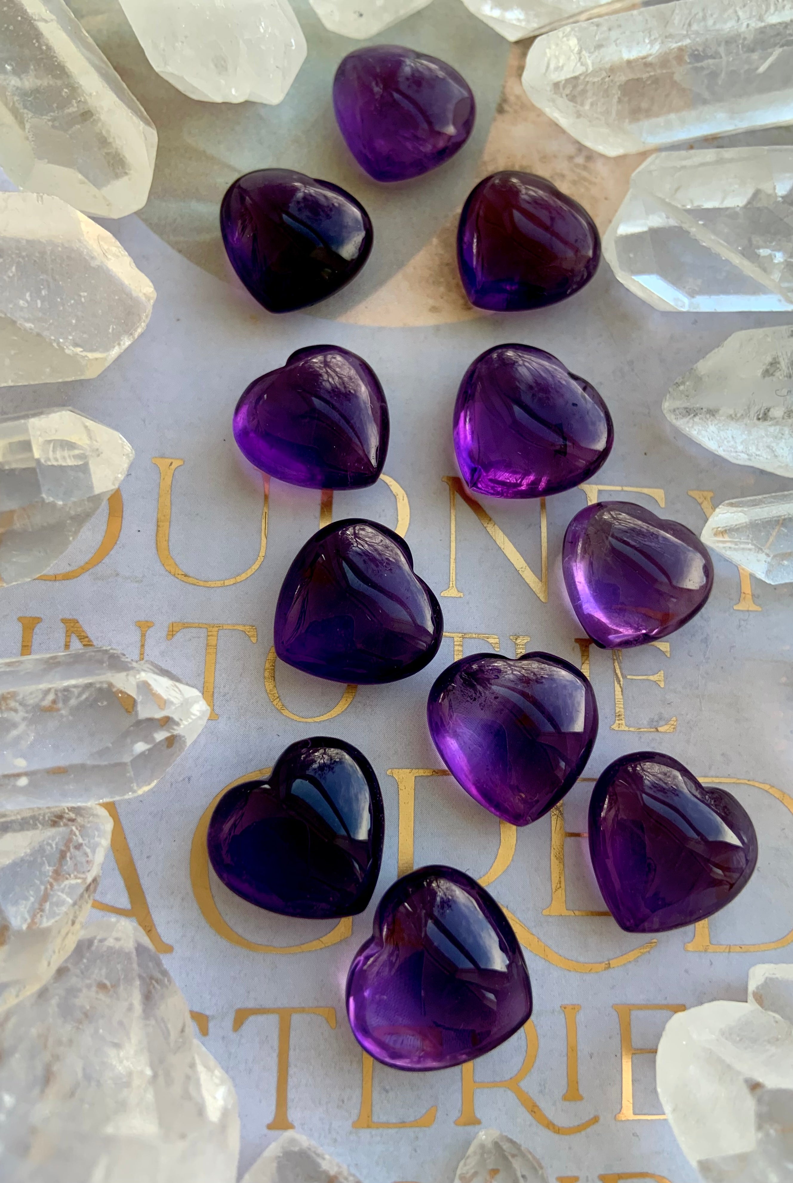 Mini Amethyst hearts surrounded by clear quartz points — purple crystal hearts for intuition and balance