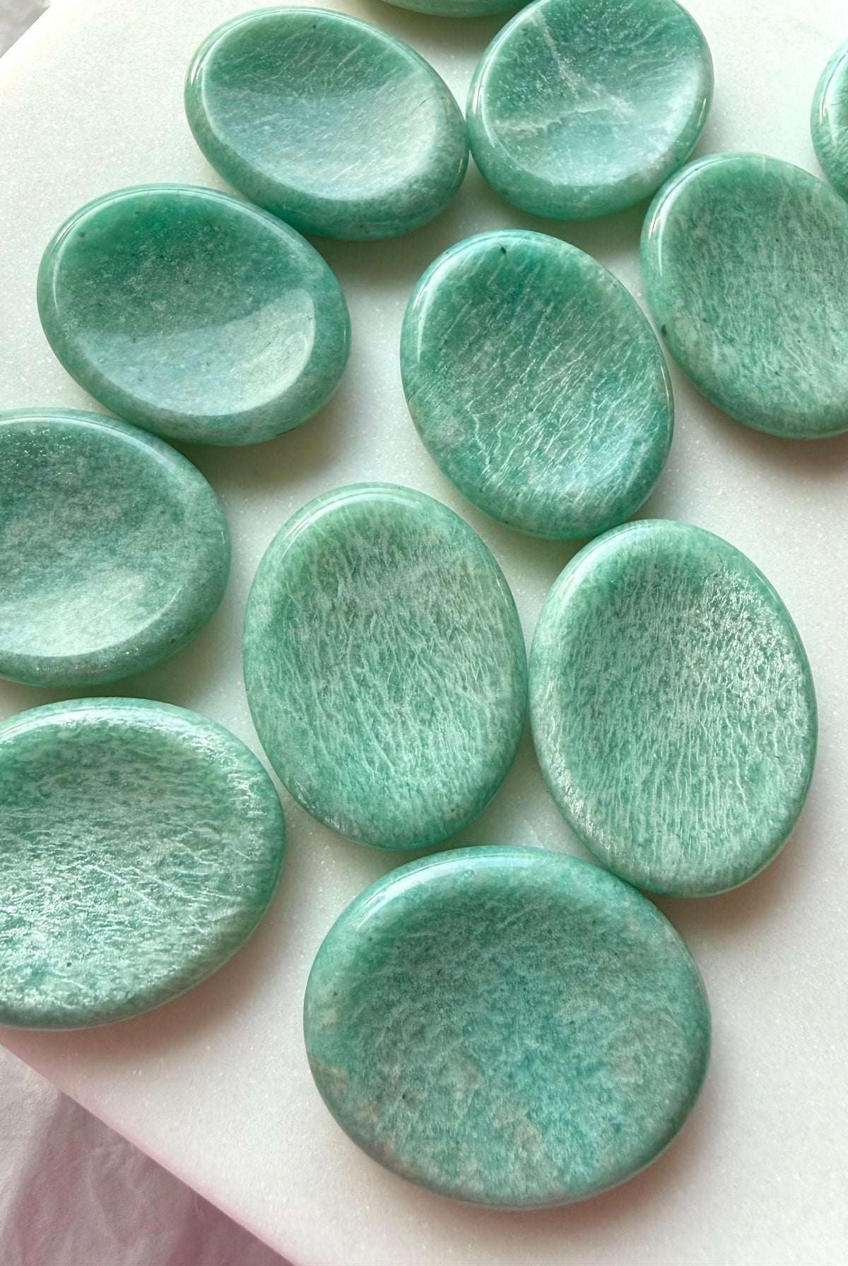 Amazonite worry stones featuring soothing turquoise-green coloring, natural white veining and polished oval thumb stones for calm and communication