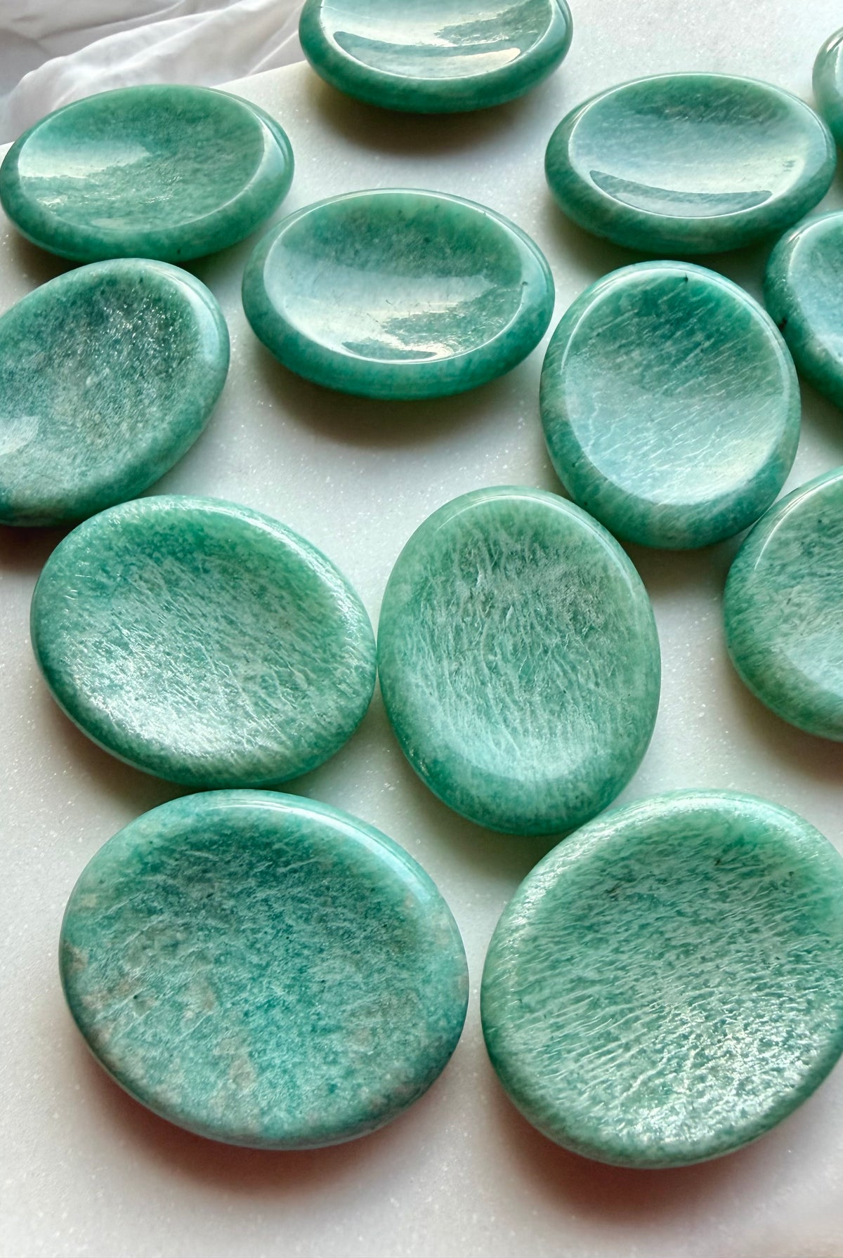 Collection of natural Amazonite worry stones with smooth thumb grooves, polished green gemstones for mindfulness and relaxation