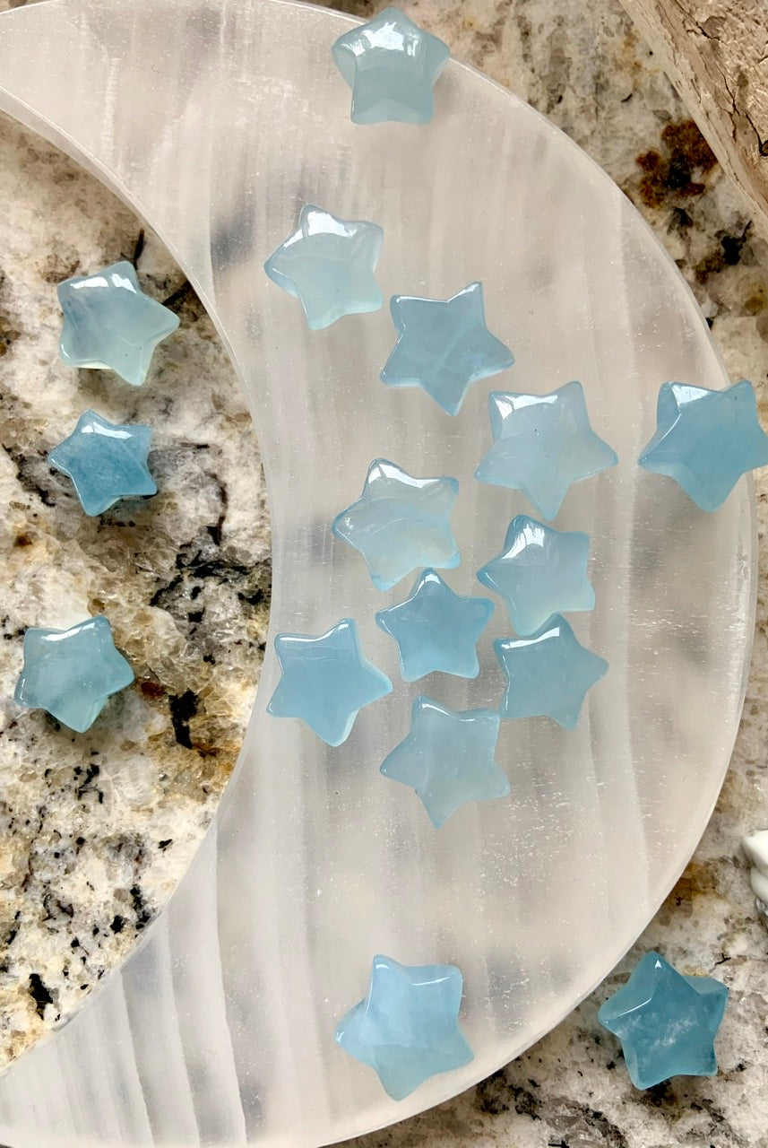 Aquamarine stars displayed on white onyx moon plate