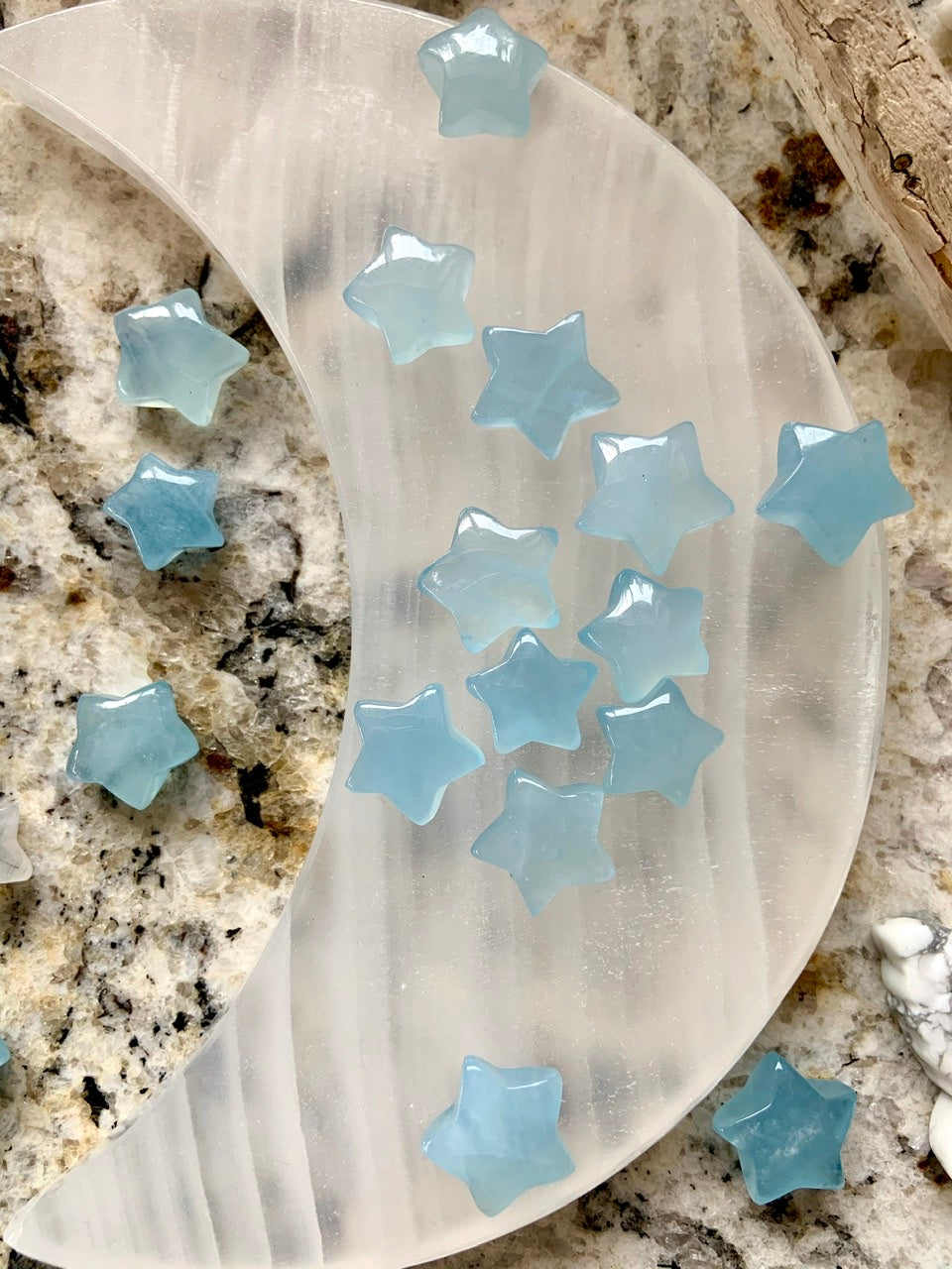 Aquamarine stars displayed on white onyx moon plate