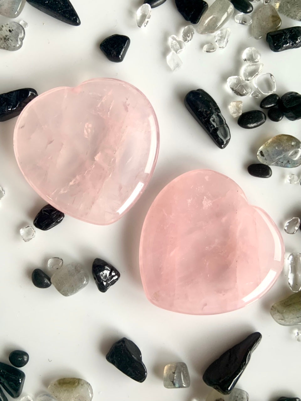 rose quartz crystal heart worry stones close up – soothing pink meditation stones for emotional healing