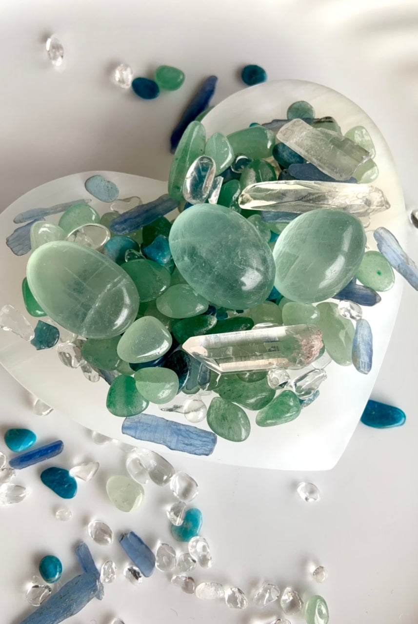 Our Blue Green Mermaid Crystal Confetti with fluorite tumbles and clear quartz points shown in a white bowl