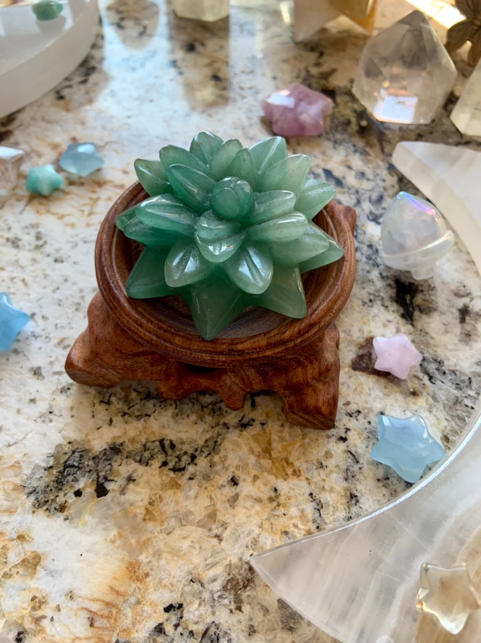 Green Aventurine crystal succulent on wooden display stand with healing crystals — shop our crystal décor & accessories for sacred spaces.