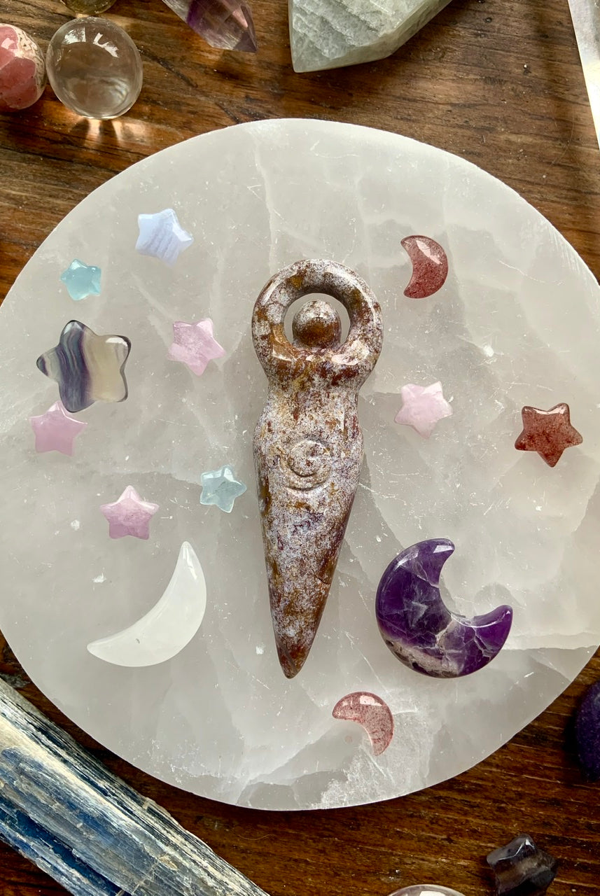 Crystal goddess carving on selenite plate with mini stars and moons in Kunzite, Fluorite, Amethyst, and Quartz — celestial altar grid for divine feminine energy and chakra healing