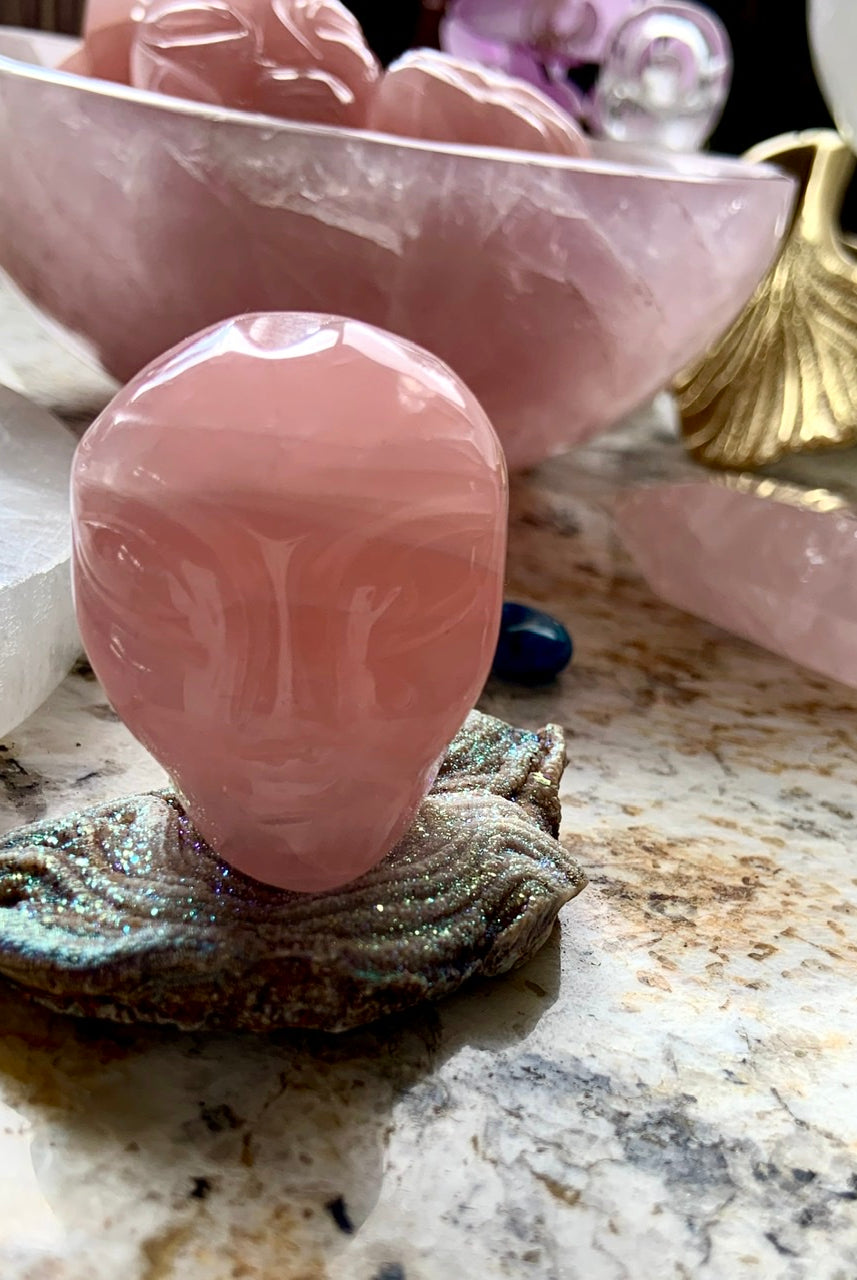 Rose Quartz alien head carving displayed on a druzy slab, galactic altar decor for starseeds