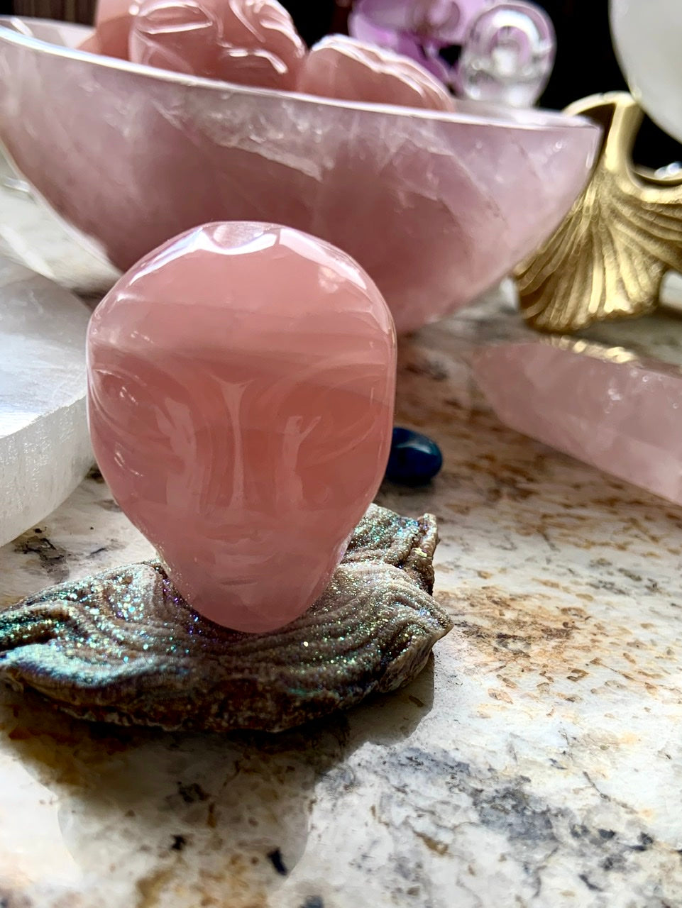 Rose Quartz alien head carving displayed on a druzy slab, galactic altar decor for starseeds
