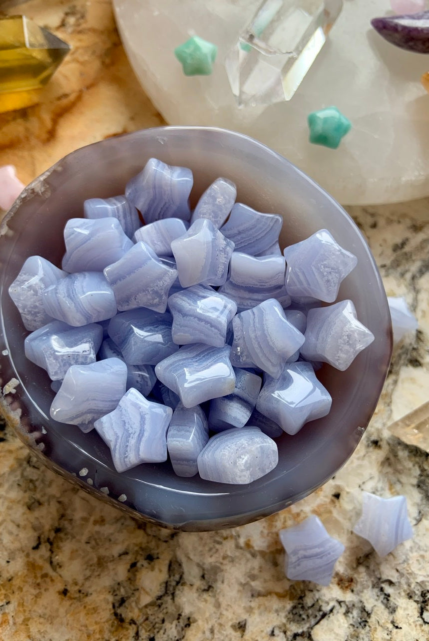 Mini Blue Lace Agate stars in a blue-gray agate bowl — calming Throat Chakra crystals for peace, clarity & gentle energy.