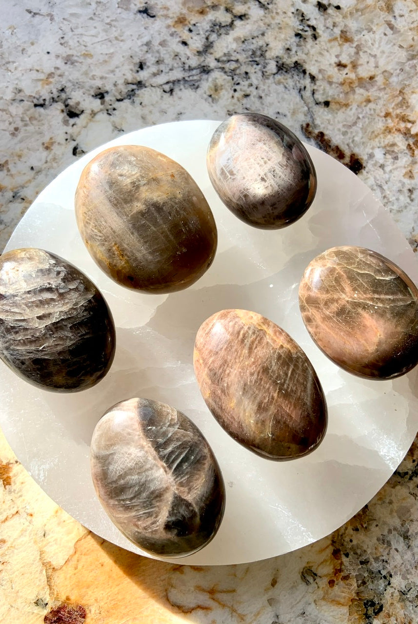 Hold a Black Moonstone Palm Stone to connect with New Moon energy and awaken your inner goddess