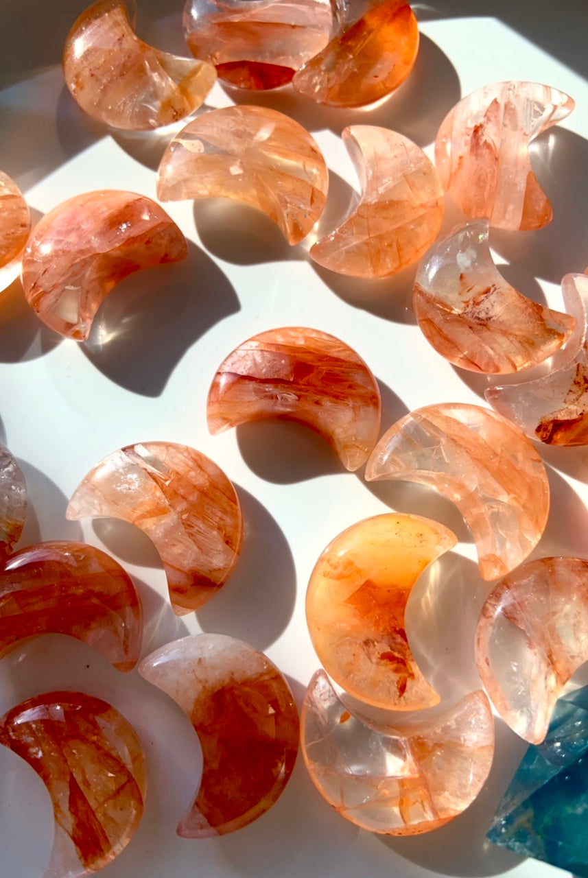 Fire Quartz with Golden Healer Moons, on a dark white background with bright contrasting lighting