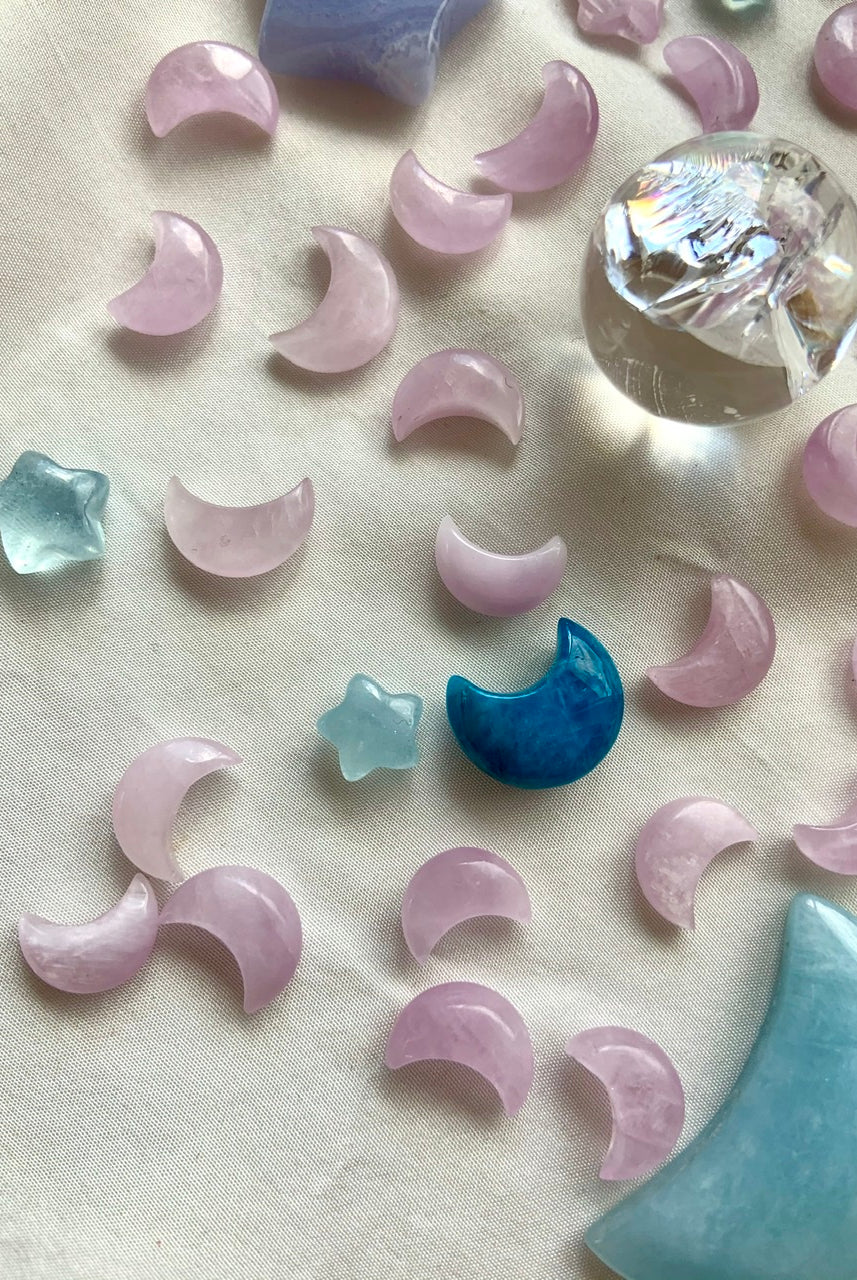 Mini Kunzite moons with celestial crystal carvings & aura quartz sphere — sacred tools for crystal grids, altars & spiritual intention.