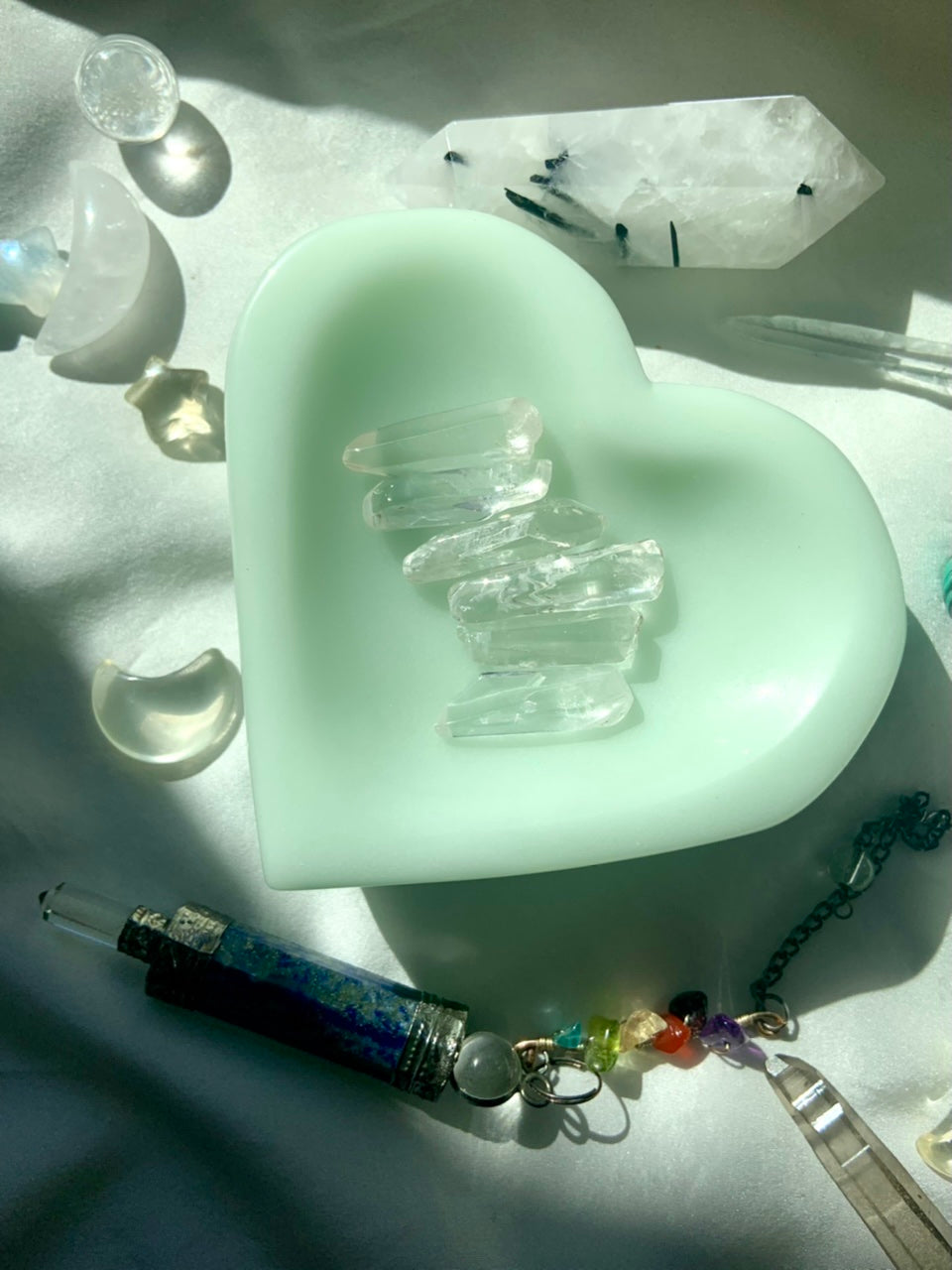 Small clear quartz points styled in green bowl for sacred space decor and altar display