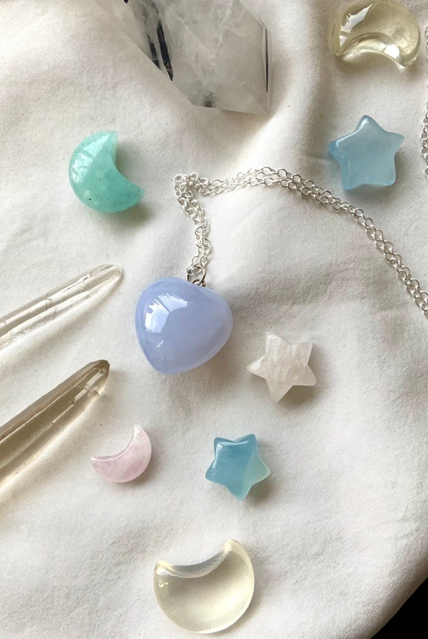 A luminous blue chalcedony heart pendant necklace on s925 silver chain makes a sweet gift her. This pastel blue crystal resonates with the throat + heart chakras promoting clear, emotionally balanced, heart-centered communication + understanding.