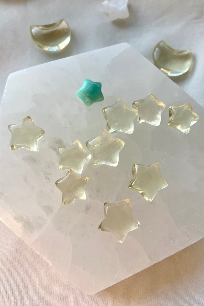 Mini citrine star carvings on a selenite plate with Amazonite — crystal stars for joy, clarity, and Solar Plexus chakra energy