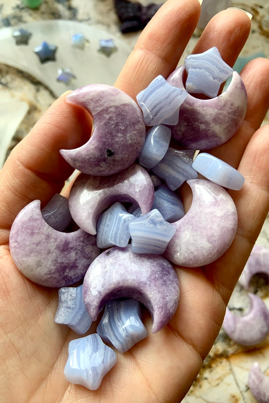 Mini Blue Lace Agate stars in hand with Lepidolite moons — gentle healing crystals for emotional balance & clear communication.