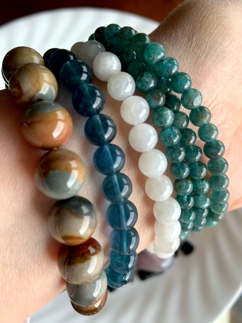 Our Polychrome Jasper bracelets shown with Teal Fluorite, White Moonstone and Blue Apatite bracelets