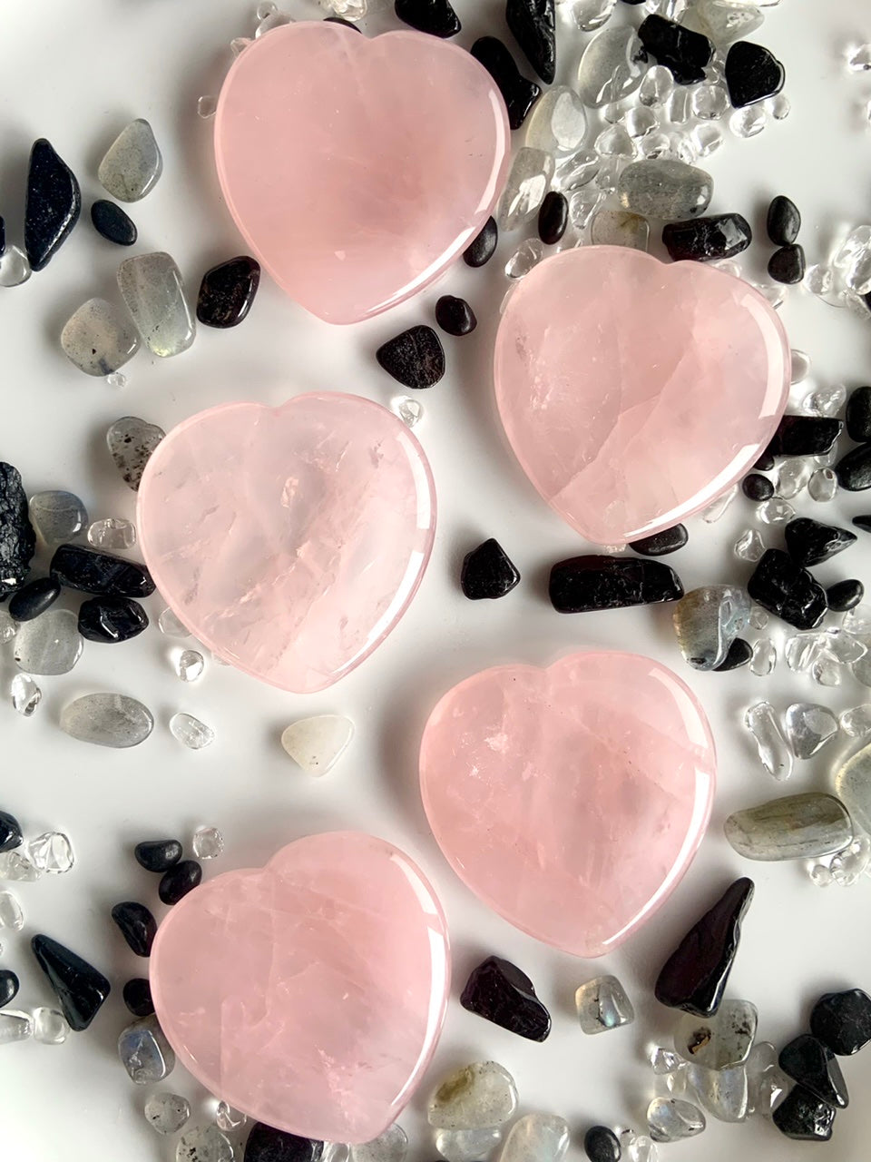 Rose quartz heart worry stones on crystal chip grid – heart chakra healing crystals for love and emotional balance