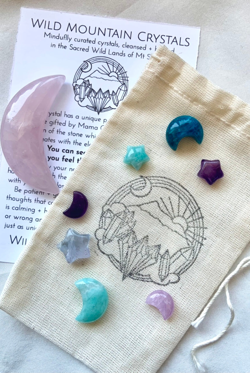 Mini Crystal Moon and Star Set of colorful celestial crystals inside a carrying pouch hand stamped with the Wild Mountain Crystals logo + info to help you ID the stones + learn to work with their crystal healing properties.