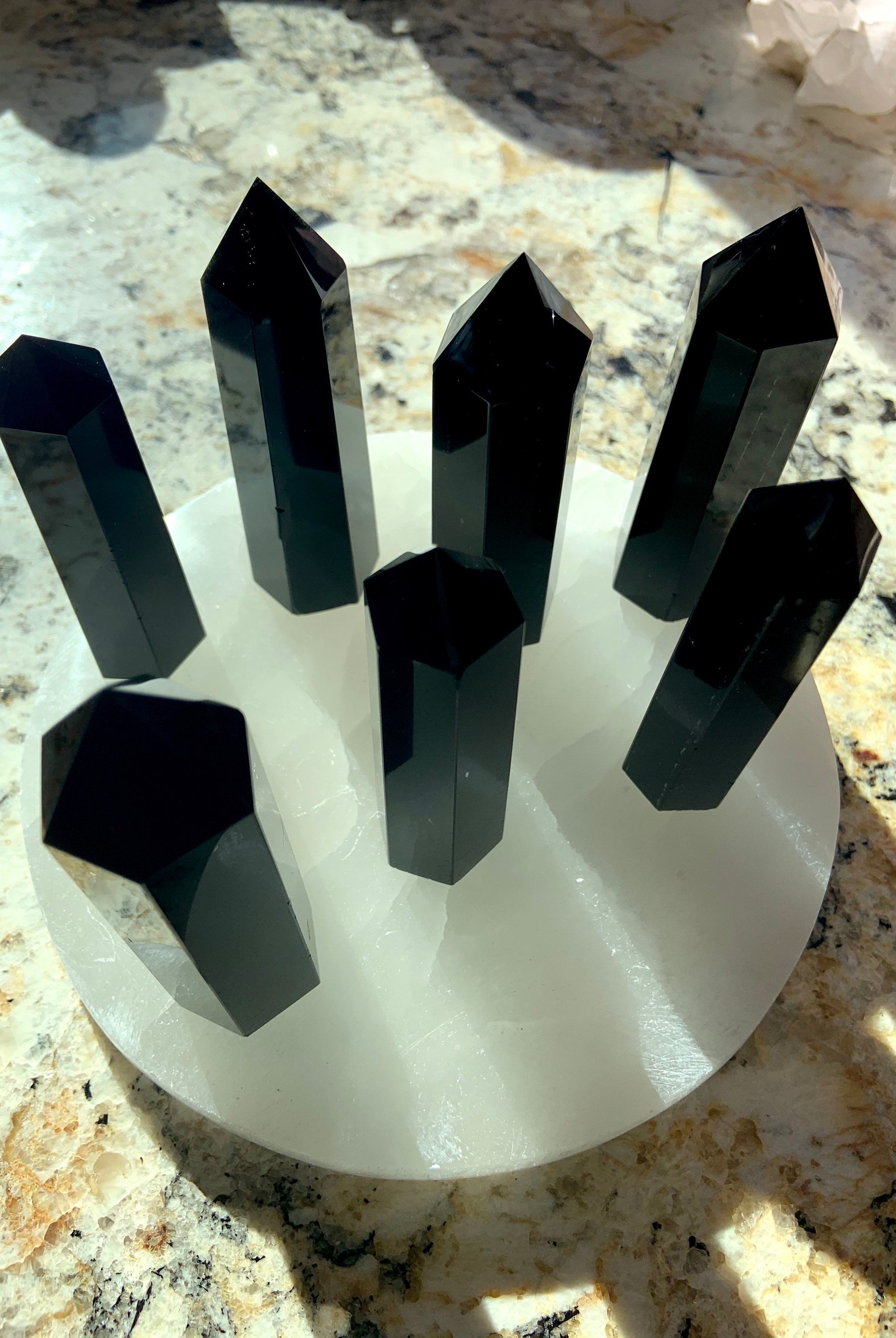 An array of black obsidian towers in the sunlight