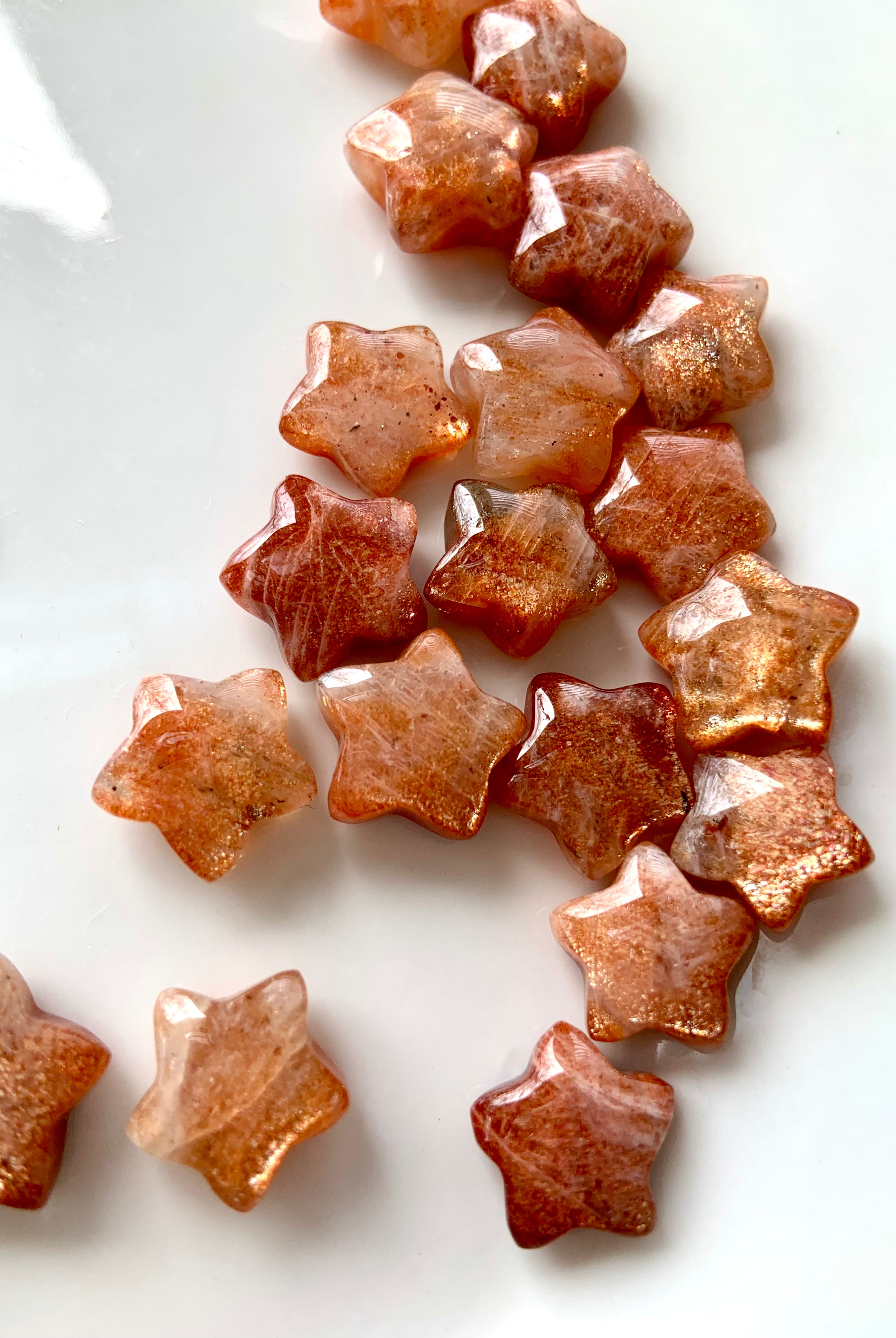 Sparkly Arusha Sunstone stars with confetti and lattice inclusions — crystal star carvings for joy, confidence, and Solar Plexus chakra healing