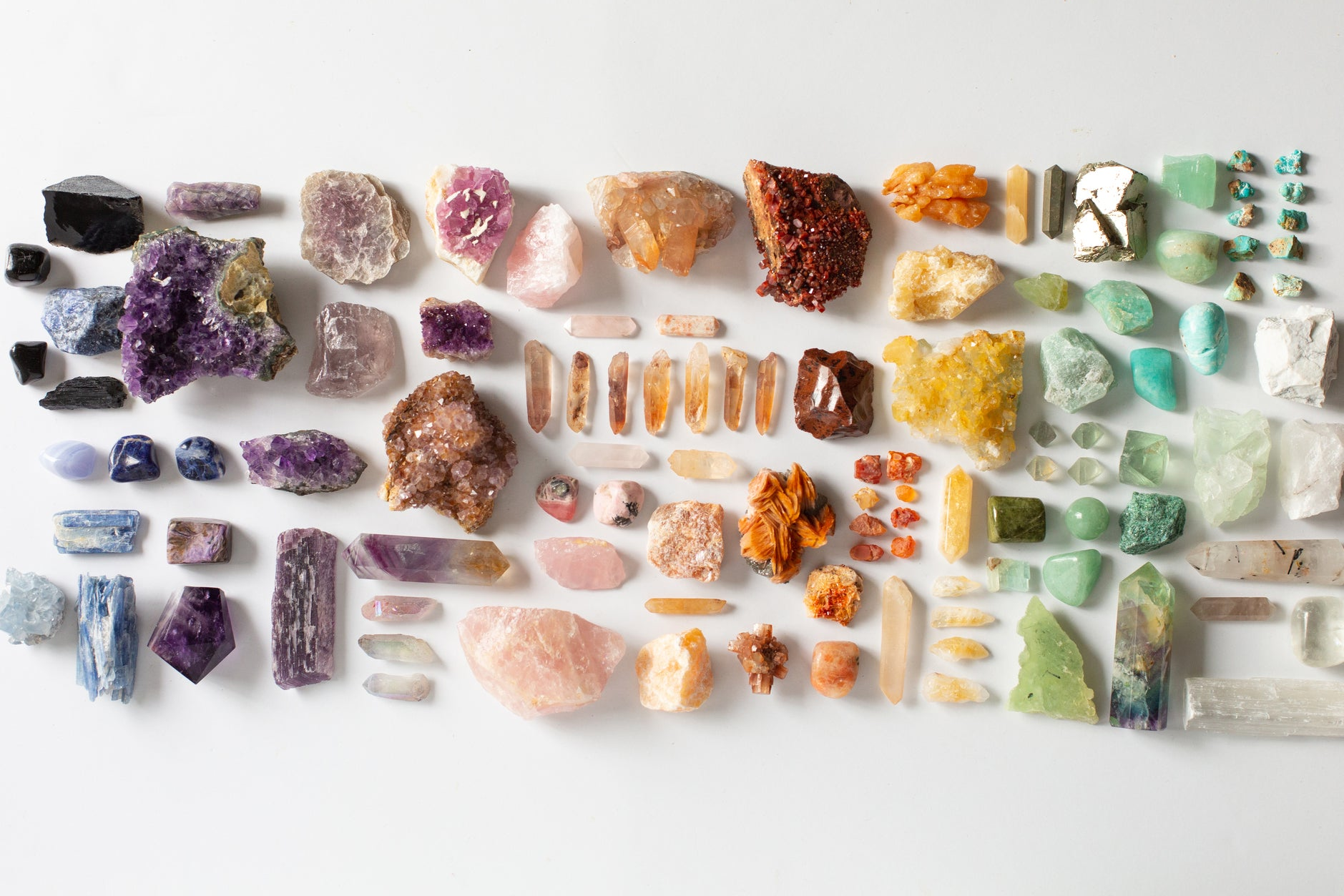Large flat lay of colorful healing crystals and gemstones, featuring raw and polished varieties like amethyst, citrine, rose quartz, and fluorite — ideal for collectors, crystal healing, energy work, and spiritual shoppers.