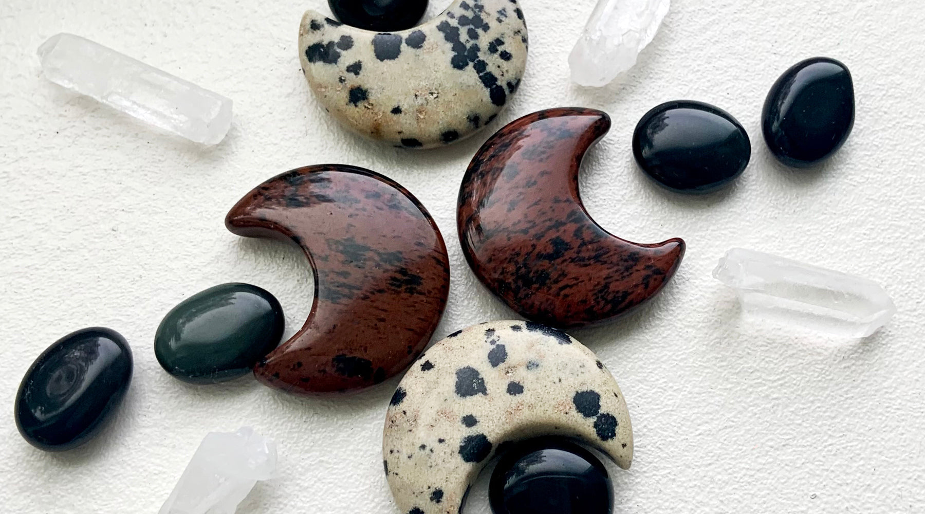 A crystal grid for energetic protection made with Mahogany Obsidian, Black Obsidian, Dalmatian Jasper, and Clear Quartz points — the perfect banner for our blog post on the crystal healing properties of Obsidian.