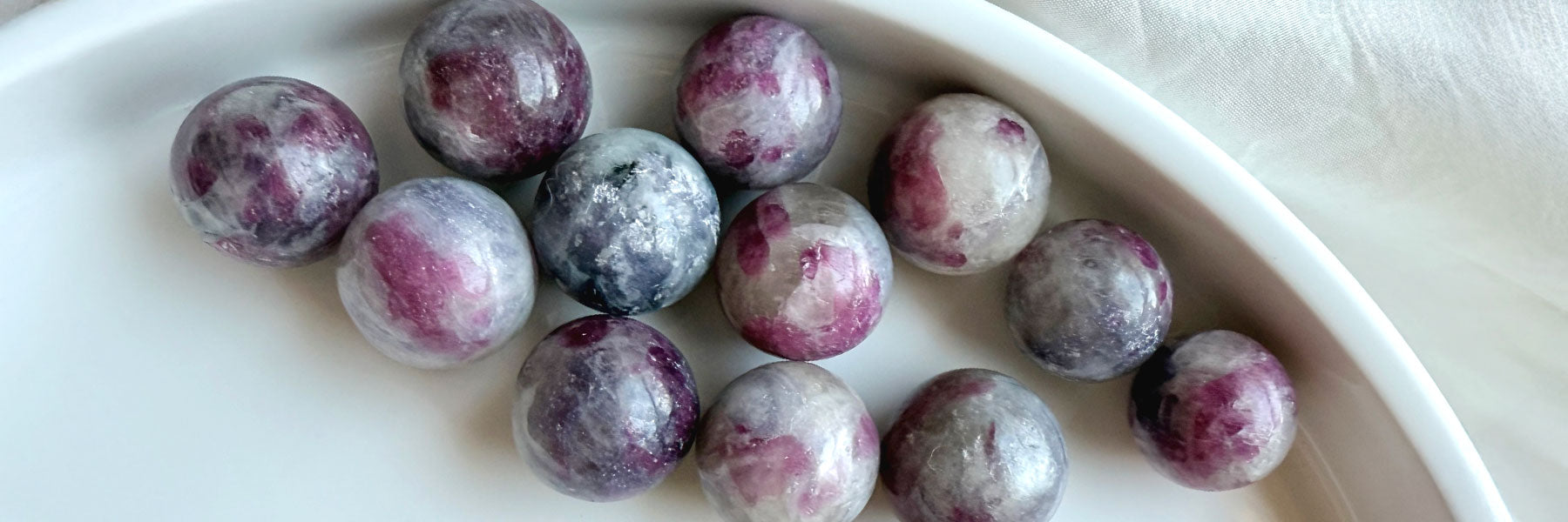 Unicorn Stone crystal spheres with pink tourmaline, lepidolite, smoky quartz & cleavelandite inclusions