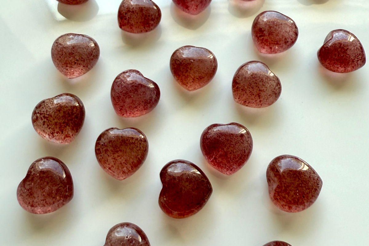 Strawberry Quartz mini hearts on white background — healing crystals for love, joy, and heart chakra alignment