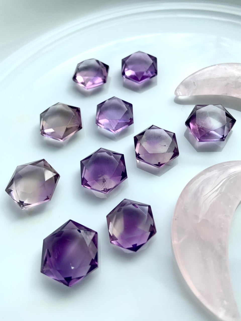 High-quality Amethyst hexagon crystals glittering in the light — sacred geometry carvings for spiritual alignment, intuition, and energy balance.