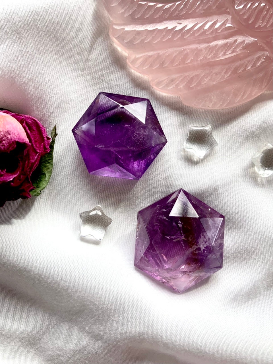 Amethyst hexagons shown on a white background with a pink rose + some crystal stars