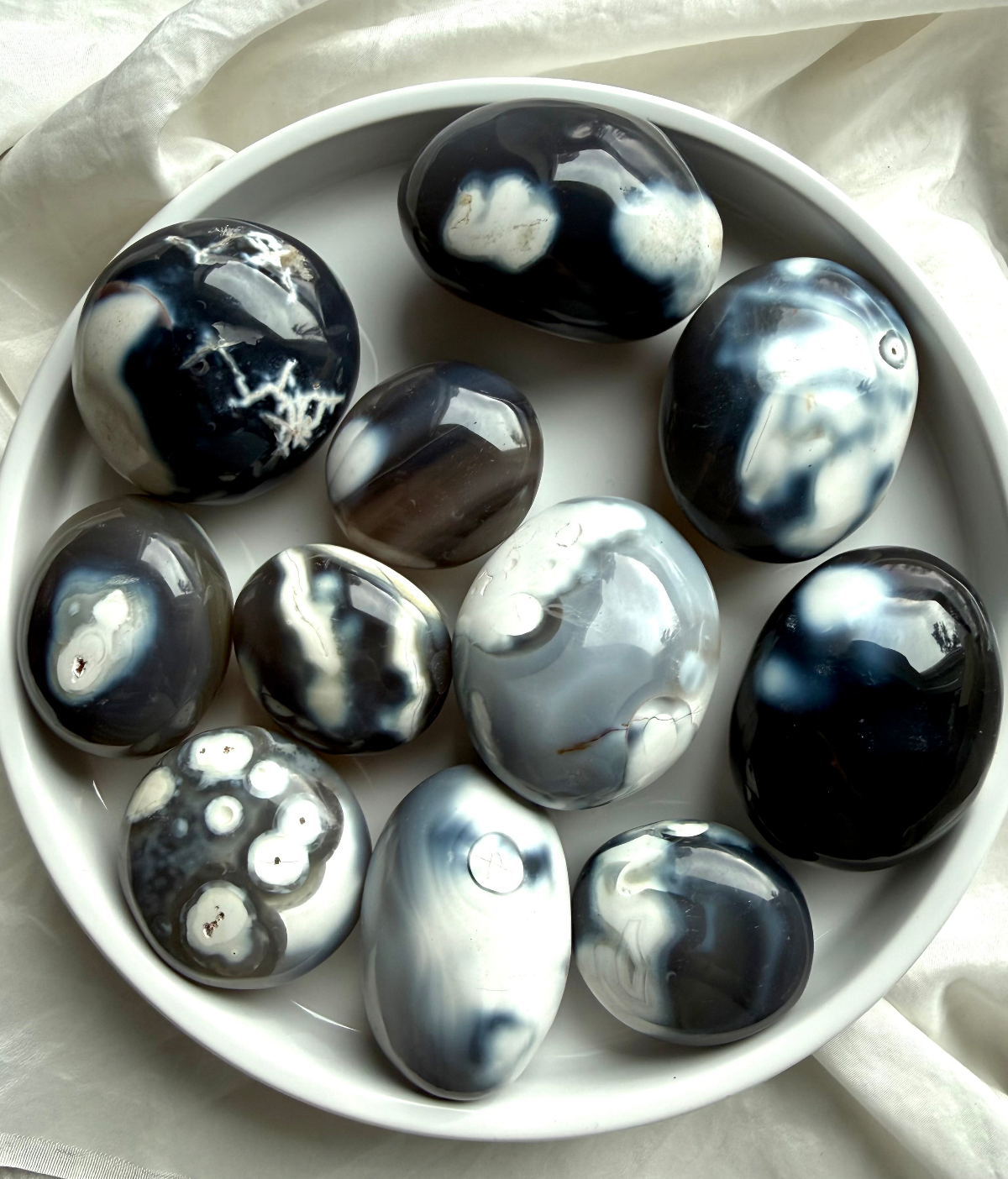 Orca Agate crystals collection featuring polished palm stones, bracelets, carvings, and healing stones for grounding, forgiveness, and emotional strength