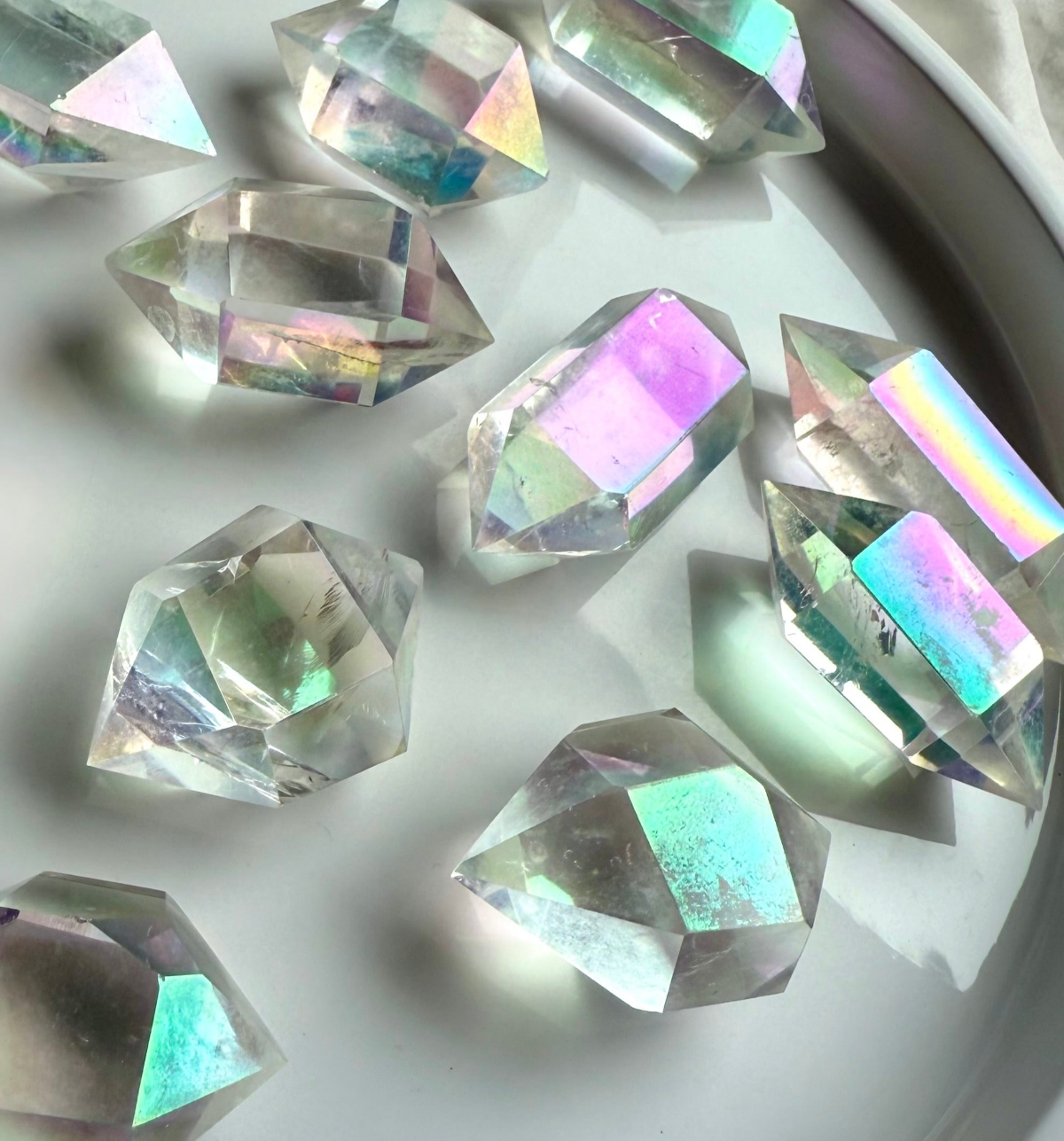 Iridescent aura quartz double terminated points with rainbow sheen — high-frequency crystals for meditation, crown chakra healing, divine connection, and spiritual transformation.
