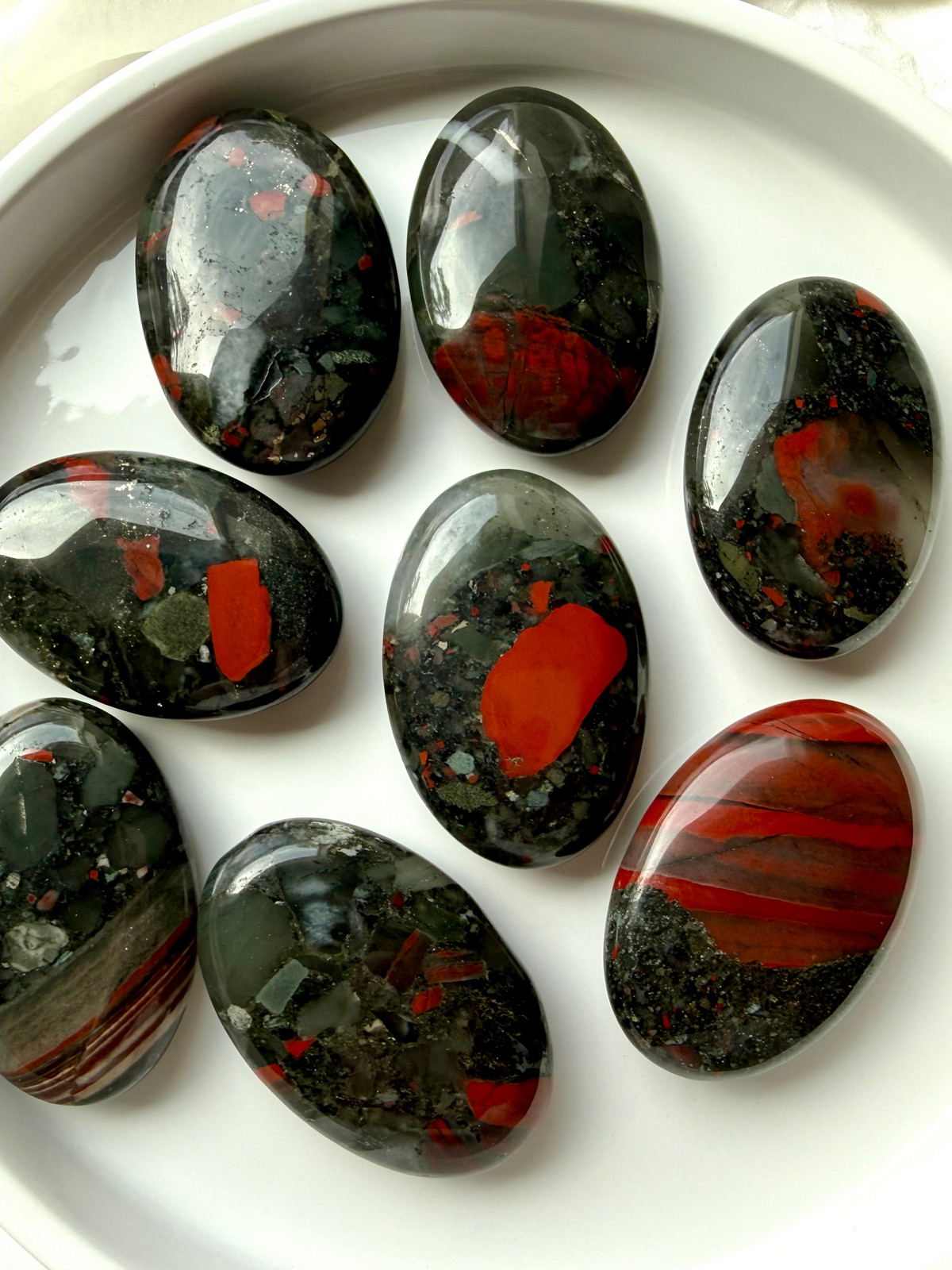 Bloodstone crystals with deep green color and natural red inclusions, grounding stones for courage, strength, vitality and protection