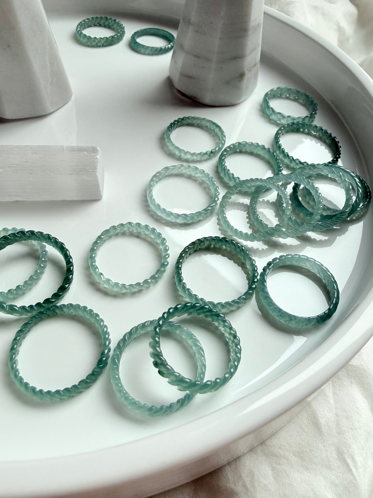 Blue Water Jade rings in woven band style, crafted from high-transparency Guatemalan jadeite with luminous teal marbling