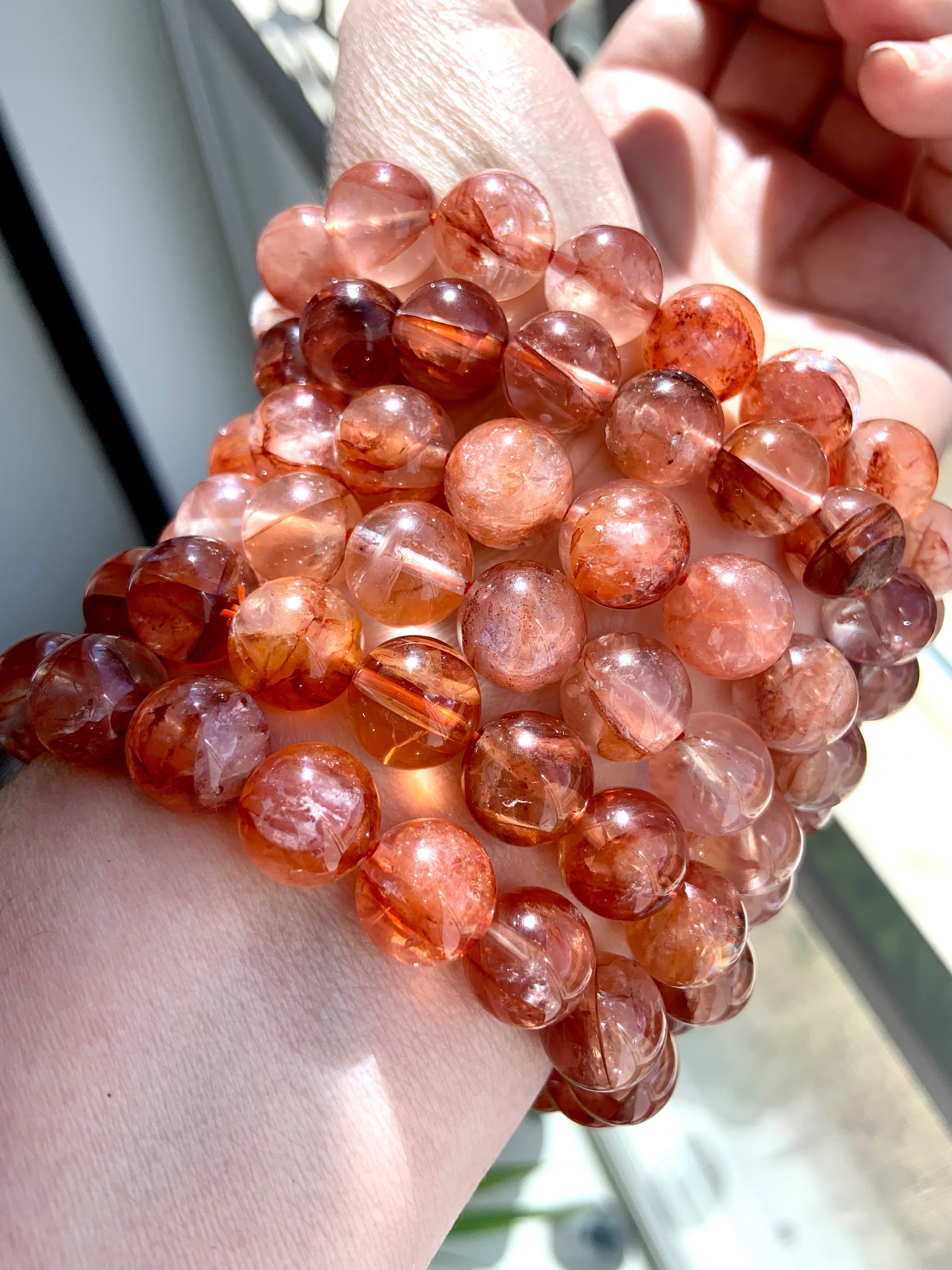 A stack of high quality Fire Quartz Bracelets by Wild Mountain Crystals