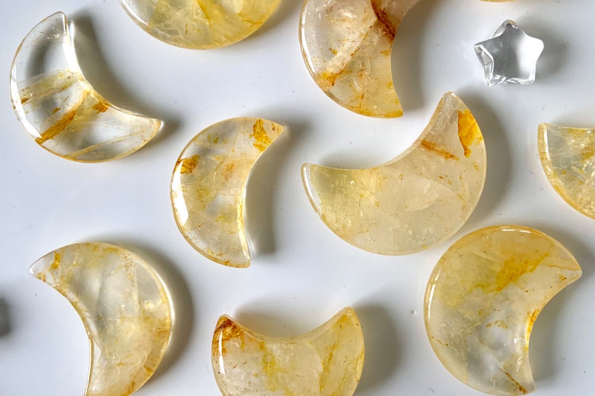 Golden Healer Quartz moon carvings for Solar Plexus Chakra healing — crystals for confidence, motivation, and personal power on white background