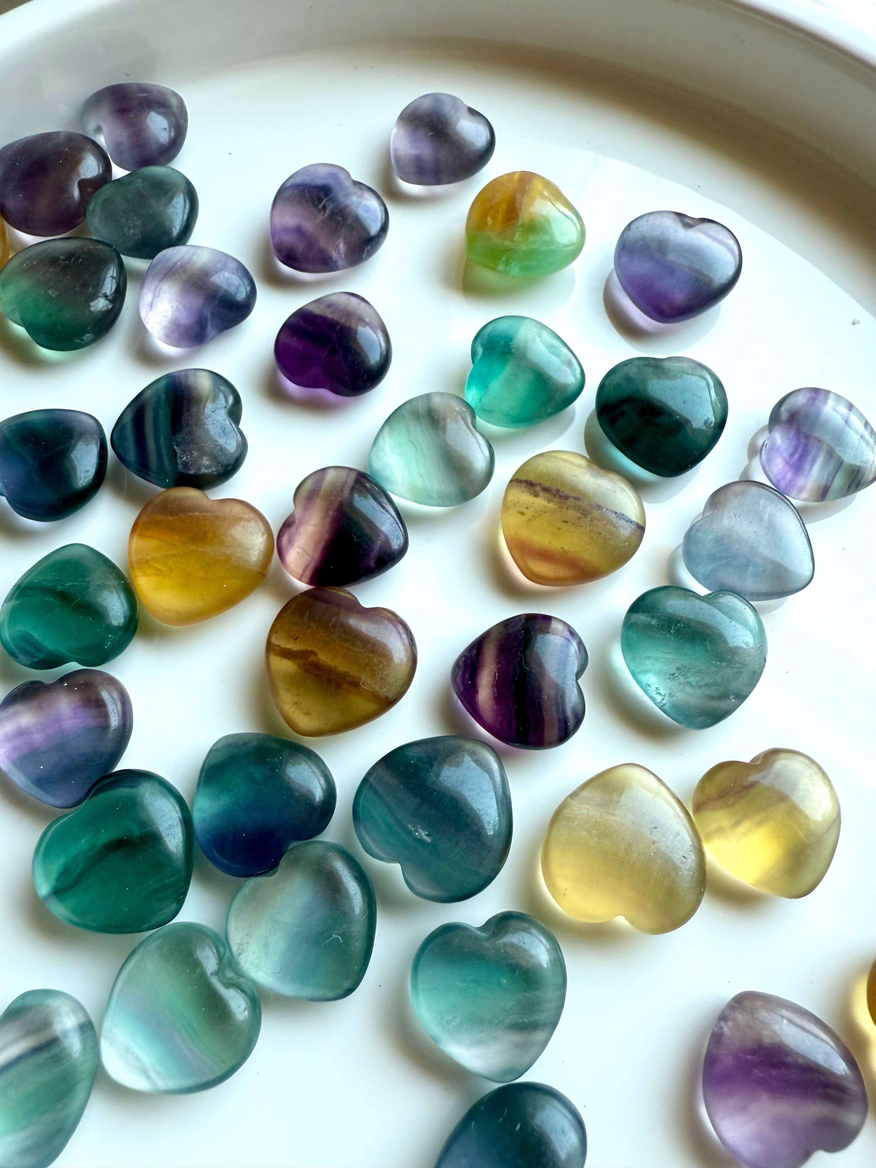 Rainbow Fluorite crystal hearts for sale in green, purple, teal, and yellow — healing stones for clarity, calm, and chakra balance.