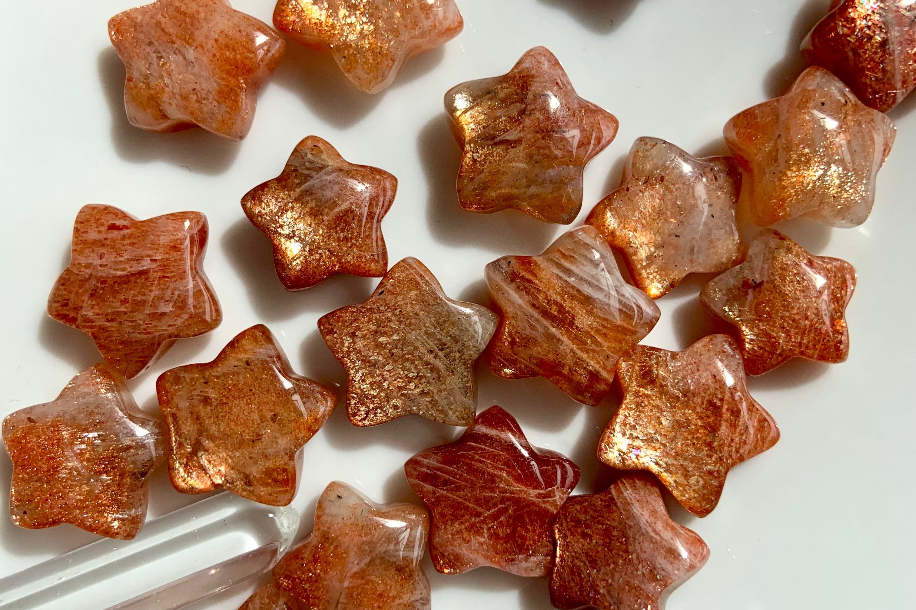 Sunstone crystal stars with glittery confetti inclusions — healing crystals for joy, abundance, empowerment, and Solar Plexus chakra alignment