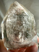 Handheld Garden Quartz phantom crystal with ancient layered formations inside clear quartz