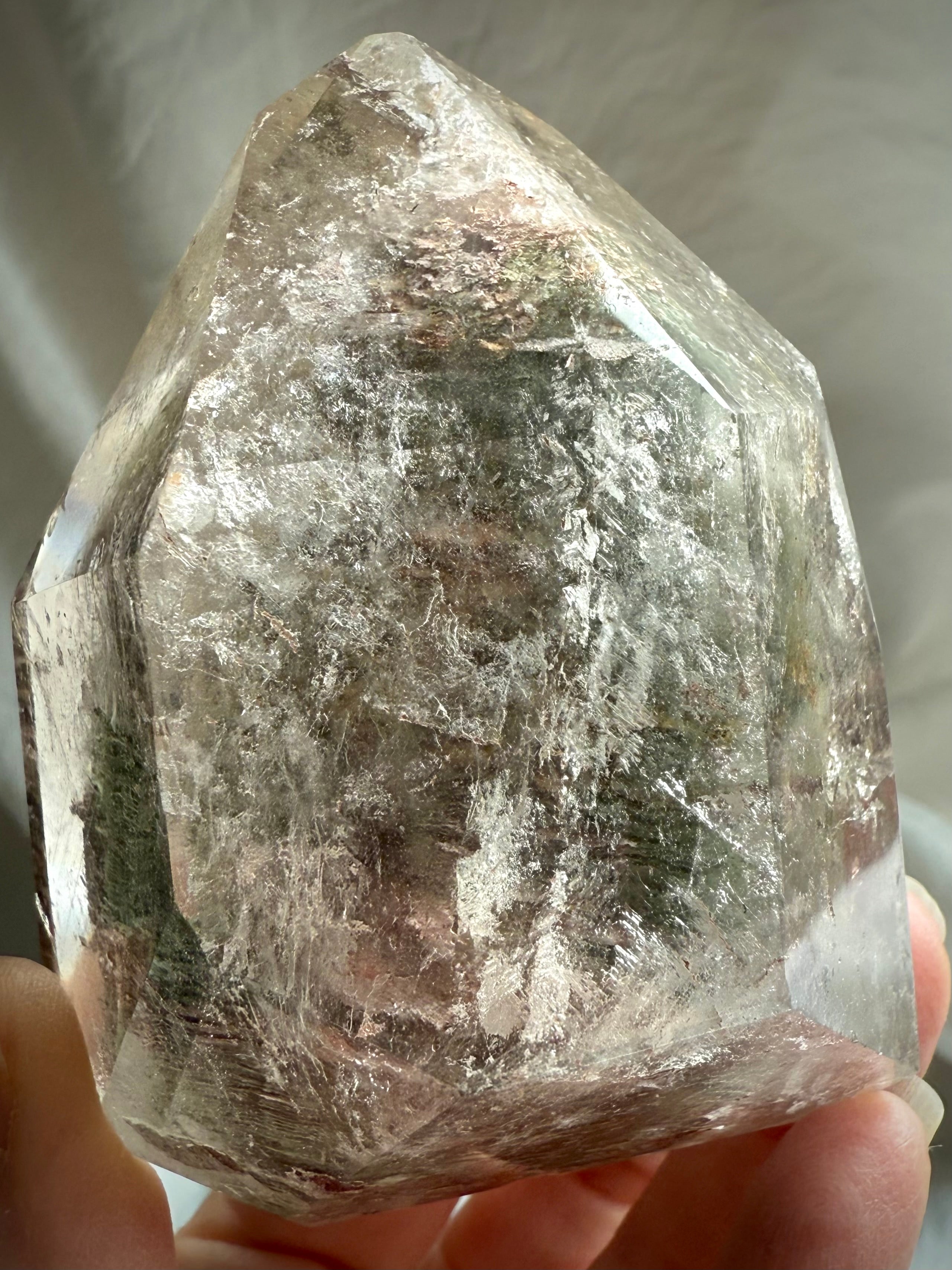 Handheld Garden Quartz phantom crystal with ancient layered formations inside clear quartz
