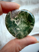 Polished Moss Agate heart worry stones showing natural variation in green inclusions and clear quartz