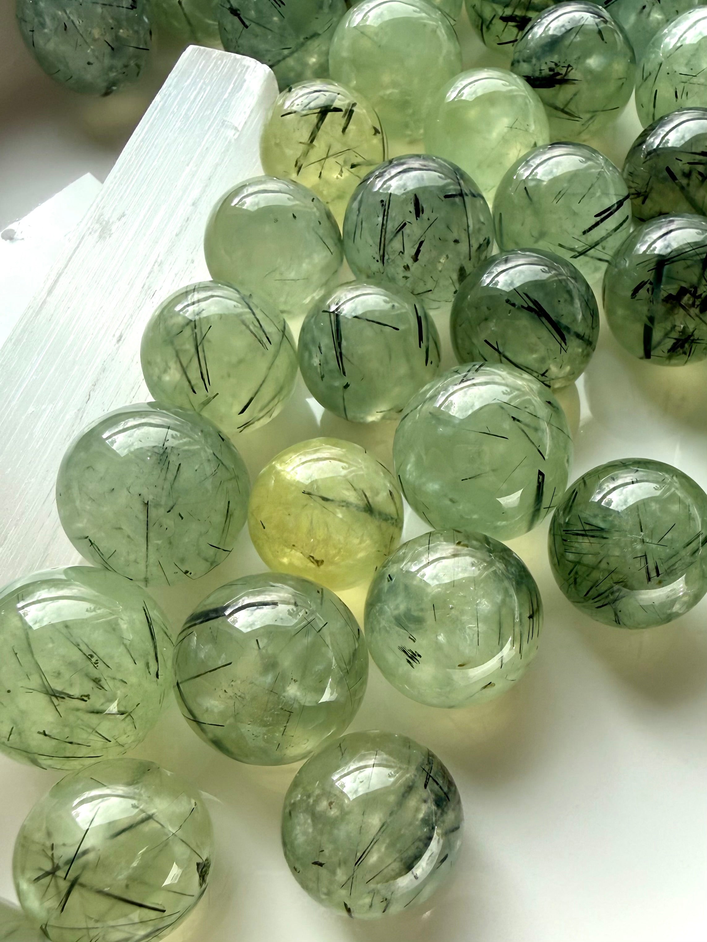 prehnite crystal spheres grouped together displaying variation in tone translucency and inclusions