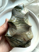 Polished Green Ocean Jasper flame with flowing banded layers and organic curves, healing stone for grounding and balance.