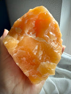 Natural Orange Calcite statement crystal with raw organic shape and glowing translucent interior