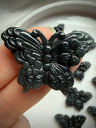 Close-up Wuji jade butterfly carving in natural Guatemalan jade crystal showing detailed butterfly wings