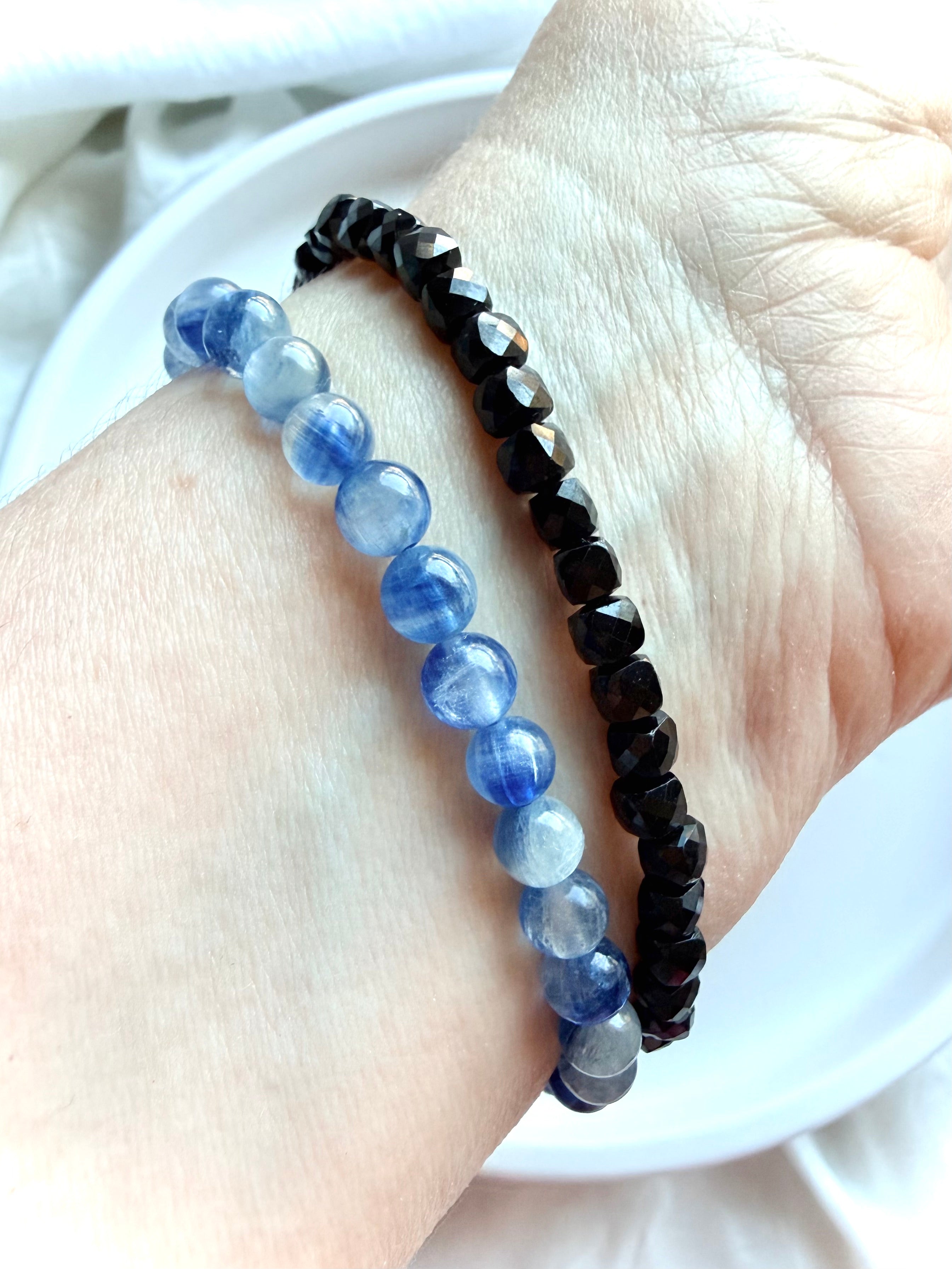 Blue Kyanite bracelet stacked with a Faceted Black Spinel bracelet for crystal jewelry styling