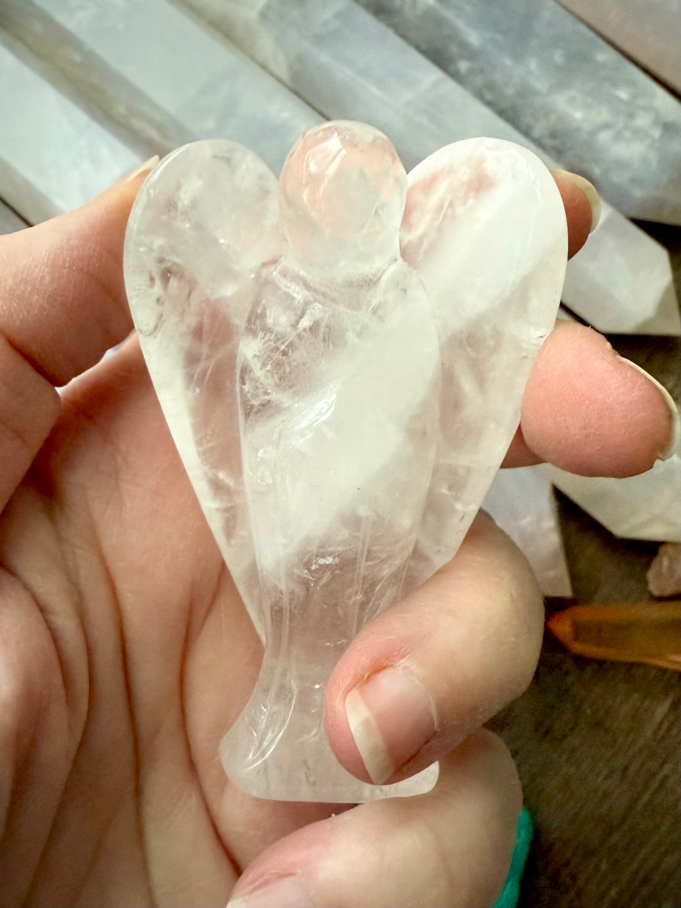 a one of a kind guardian angel hand-carved from natural clear quartz crystal to hold in meditation